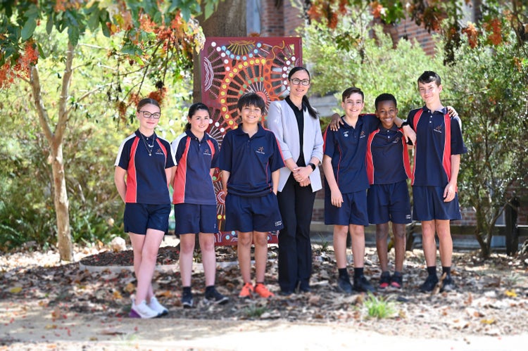 Mrs Azzopardi standing with students in the garden